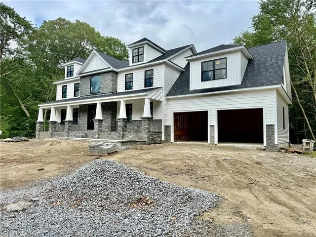a front view of a house with yard and trees