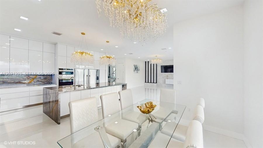 8350 Royal County Down Road Boca Raton, FL 33434 - Photo 6 of 52 a large white kitchen with lots of appliances a sink and cabinets