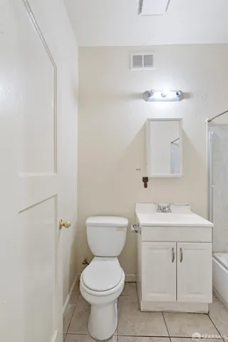 a bathroom with a sink toilet and mirror