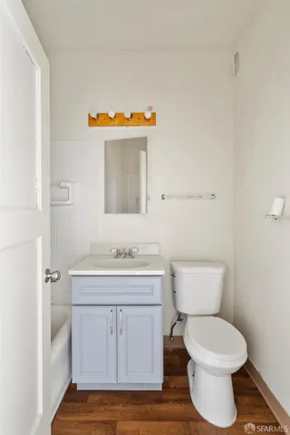 a bathroom with a toilet sink and mirror