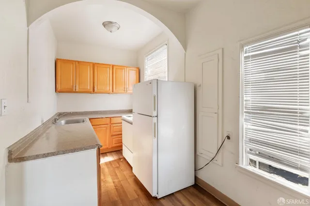 a kitchen with a refrigerator and a sink