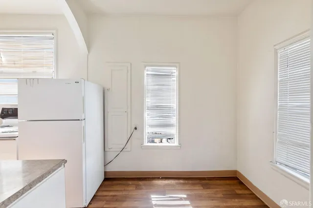 a view of a kitchen with a sink dishwasher and a refrigerator