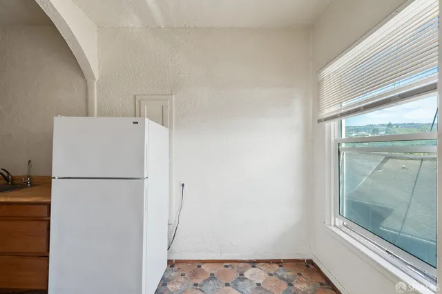 a white refrigerator freezer and a granite counter top