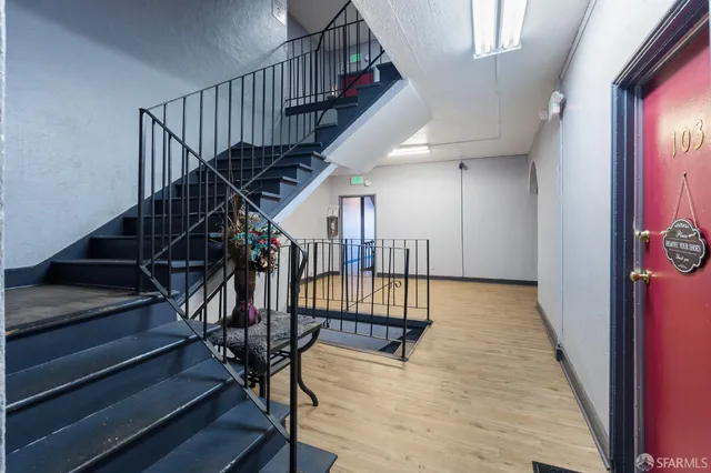 a view of entryway and hall with wooden floor