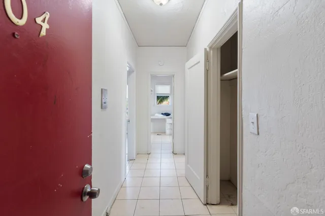 a view of a hallway with wooden shelves