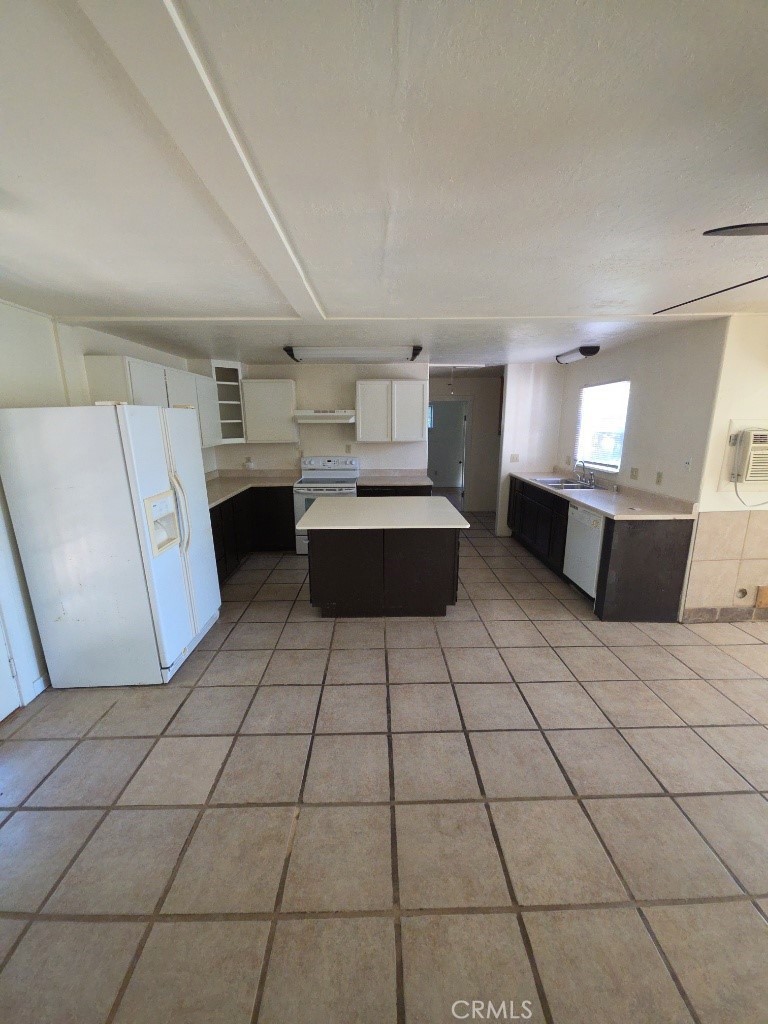 9633 Middle Creek Road Upper Lake, CA 95485 - Photo 3 of 18 a large white kitchen with a stove a sink dishwasher and a refrigerator