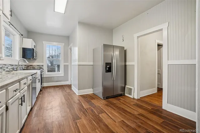 a kitchen with stainless steel appliances a refrigerator and a stove top oven