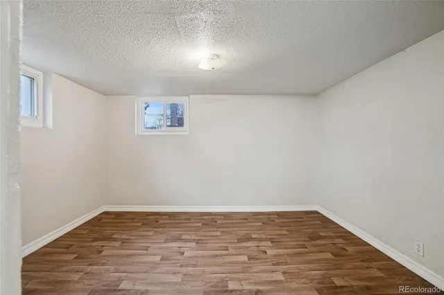 a view of a room with wooden floor and white walls