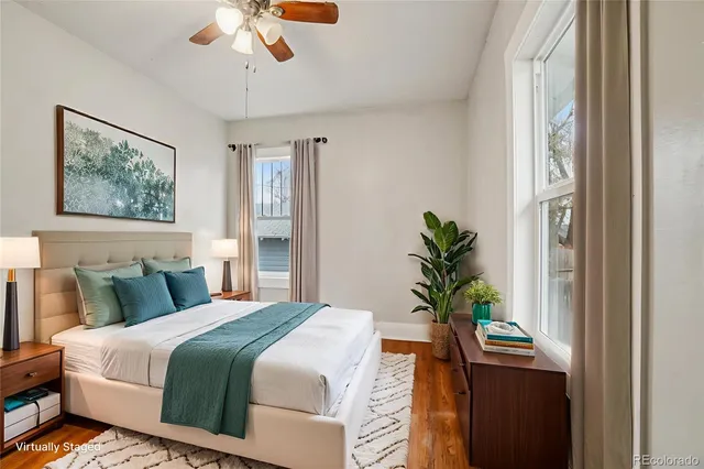 a bedroom with a bed and a potted plant