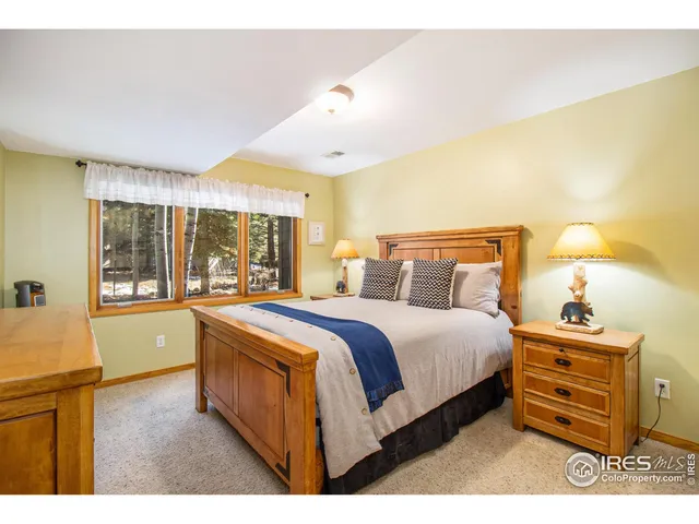 a spacious bedroom with a bed and a window