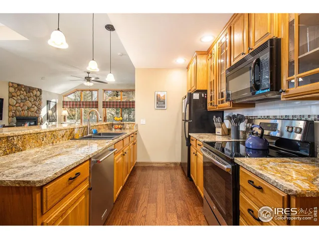 a kitchen with stainless steel appliances granite countertop a stove and a sink
