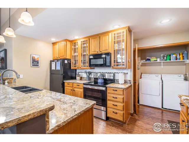 a kitchen with a stove a sink a refrigerator and a dining table