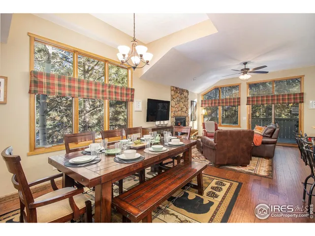 a living room with furniture a chandelier and a flat screen tv
