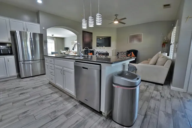 a kitchen with a sink and a mirror