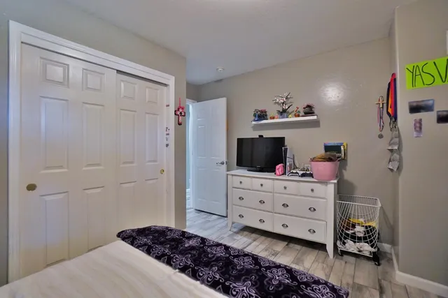 a bedroom with double bed and a window