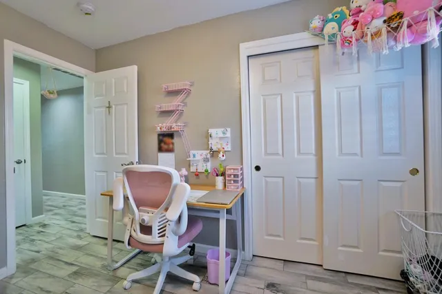 a bedroom with a bed wooden floor and window
