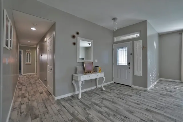a living room with fireplace furniture and a chandelier
