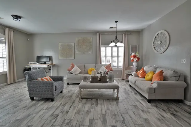 a view of room with wooden floor and windows