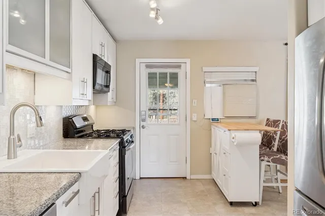 a view of a dining room with furniture a chandelier and wooden floor