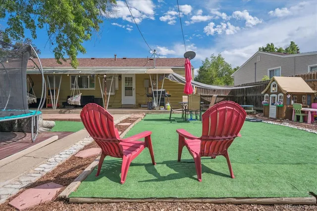 a view of a backyard with sitting area