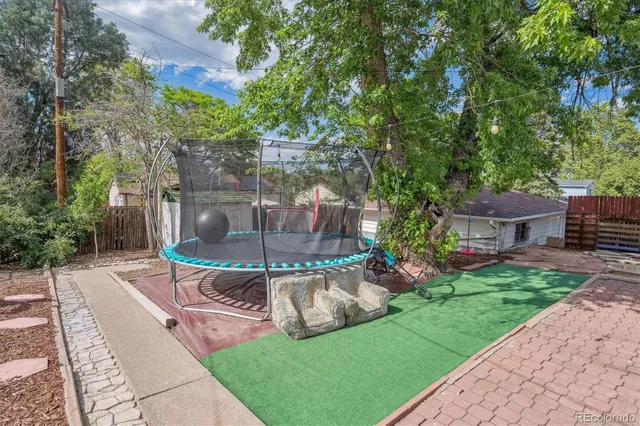 a view of a couches in patio with a backyard