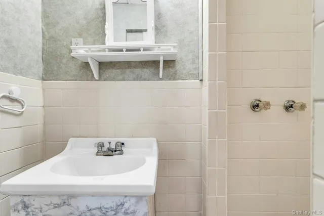 a bathroom with a sink a toilet and mirror