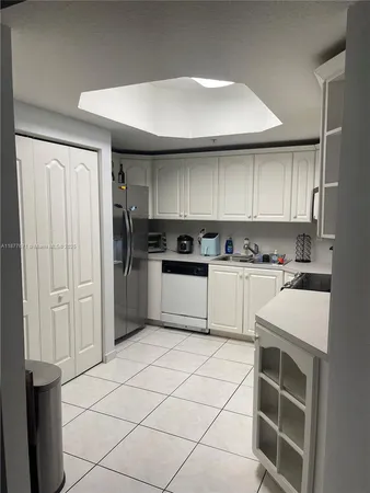 a kitchen with cabinets and white stainless steel appliances