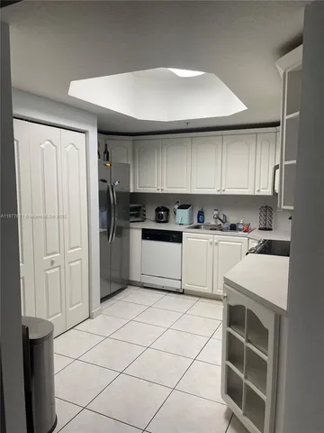 a kitchen with cabinets and white stainless steel appliances