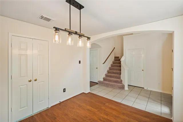 a view of a room with wooden floor and white walls