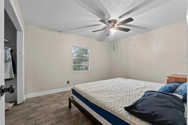 a bedroom with a bed and a chandelier