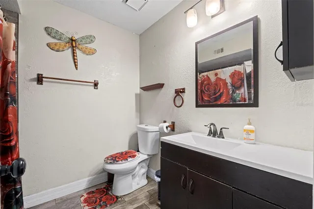 a bathroom with a sink mirror and toilet