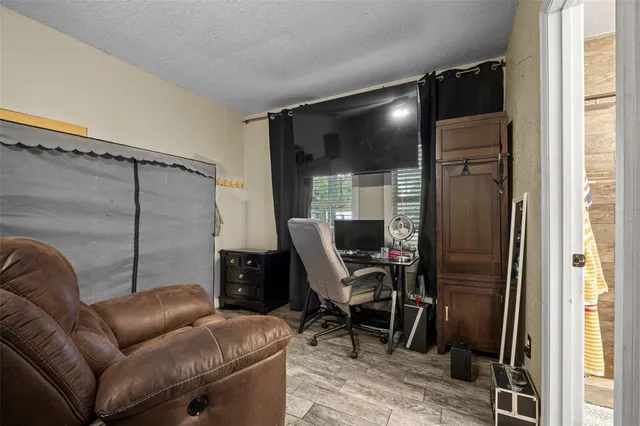 a livingroom with workspace and a window