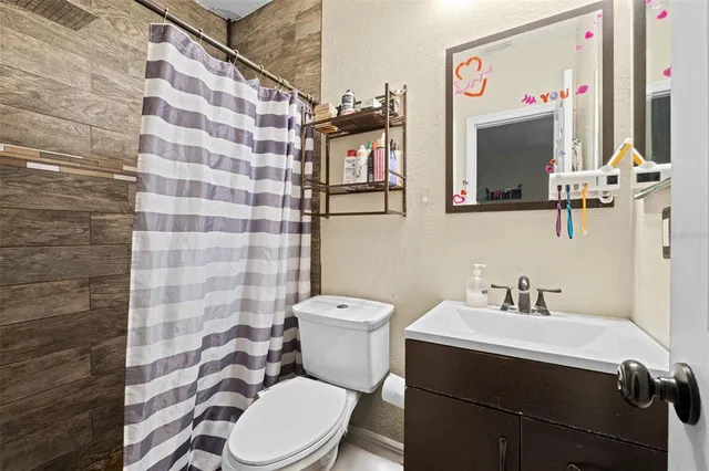 a bathroom with a sink mirror vanity and toilet