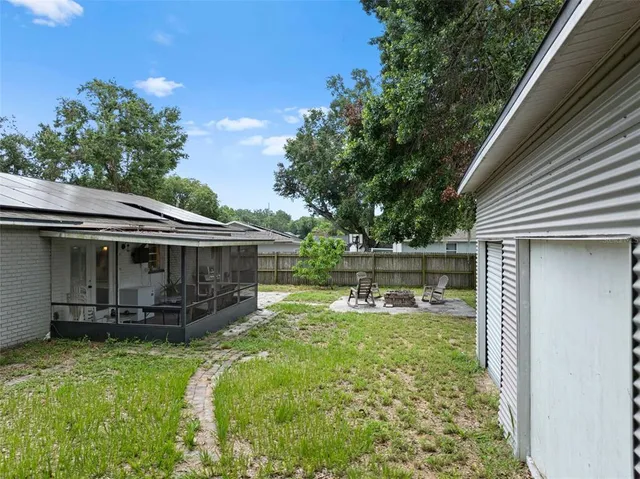 a view of a house with a yard and sitting area