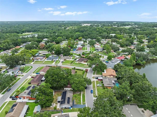an aerial view of residential houses with outdoor space and street view