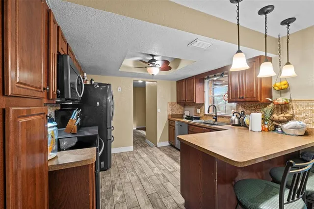 a kitchen with a sink a stove and a refrigerator
