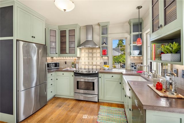 a kitchen with stainless steel appliances granite countertop a refrigerator and stove