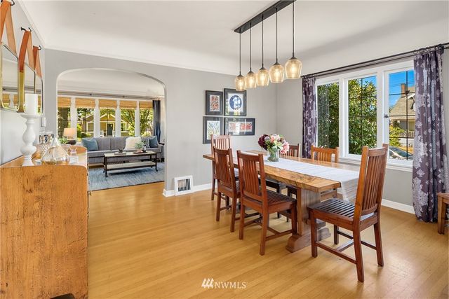 a view of a dining room with furniture large windows and wooden floor