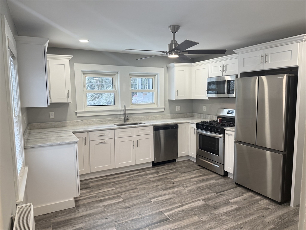794 Sandwich Road Falmouth, MA 02536 - Photo 5 of 17 a kitchen with granite countertop a refrigerator stove and oven