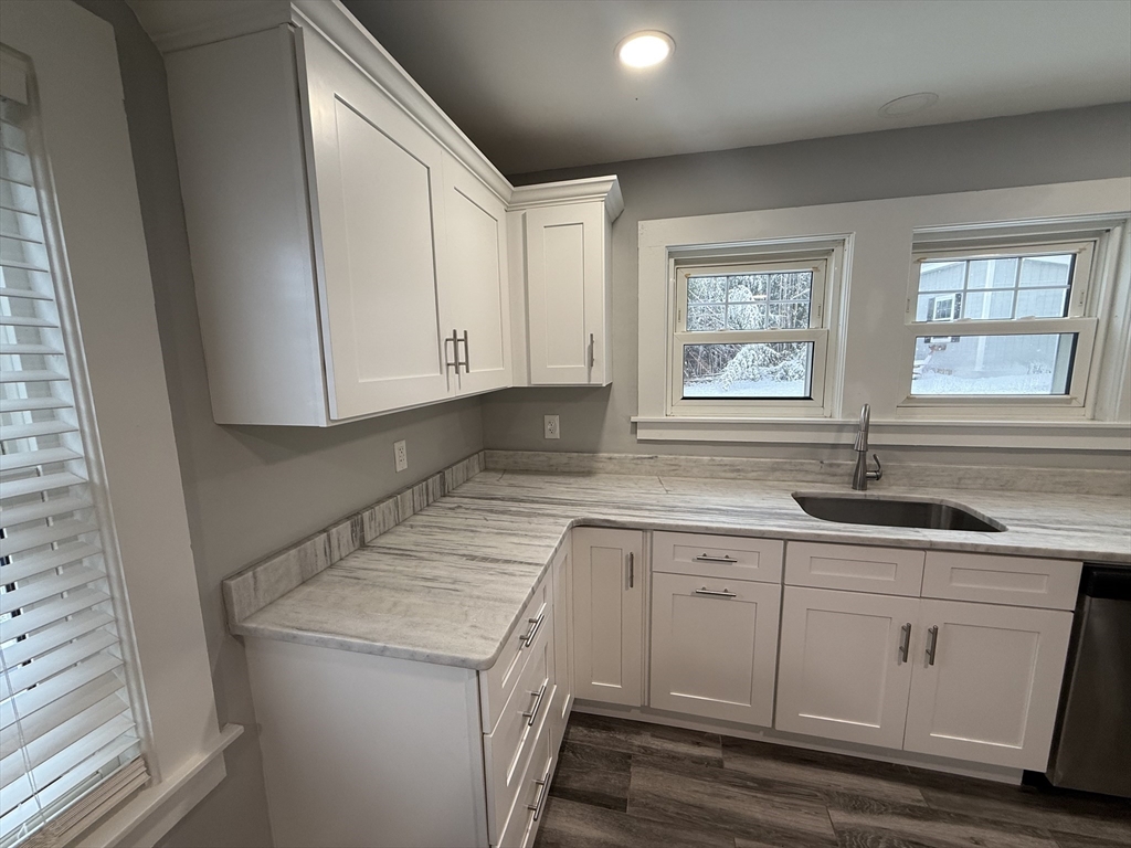 794 Sandwich Road Falmouth, MA 02536 - Photo 6 of 17 a kitchen with a sink stove and cabinets