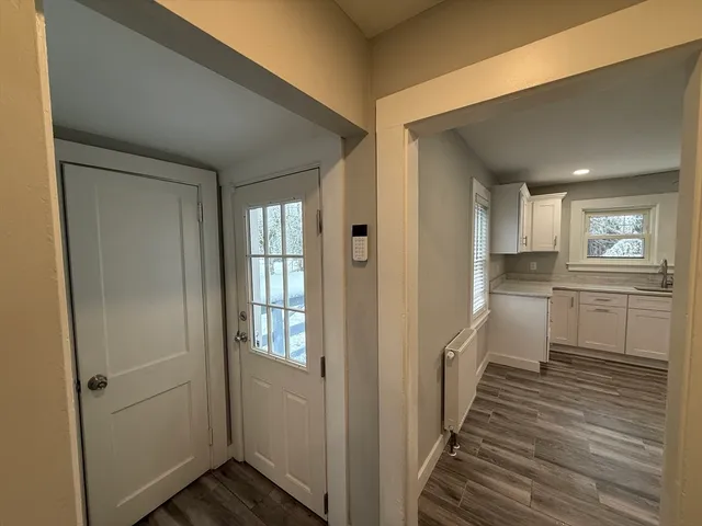 a bathroom with a tub a sink and glass door