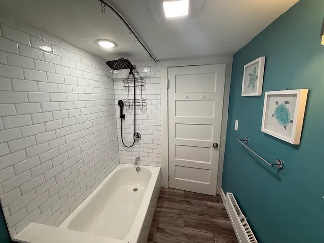 a view of a hallway with wooden floor and stairs