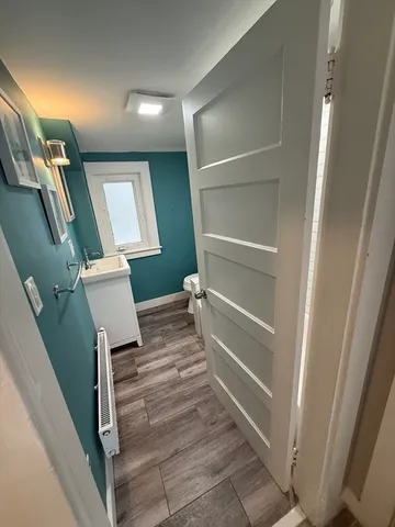 a bathroom with a toilet a sink and mirror