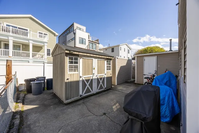 a front view of a house with outdoor seating