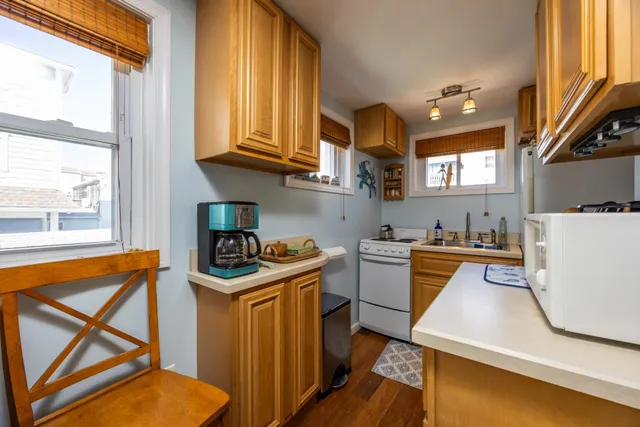 a kitchen with a stove a sink and a refrigerator