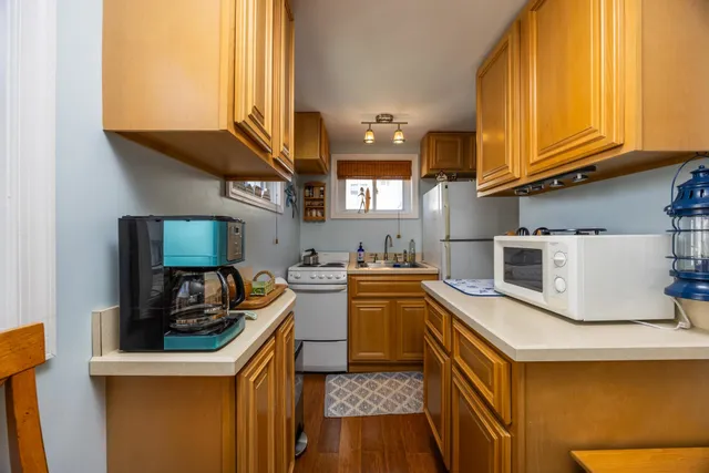 a kitchen with stainless steel appliances granite countertop a sink a stove and a refrigerator