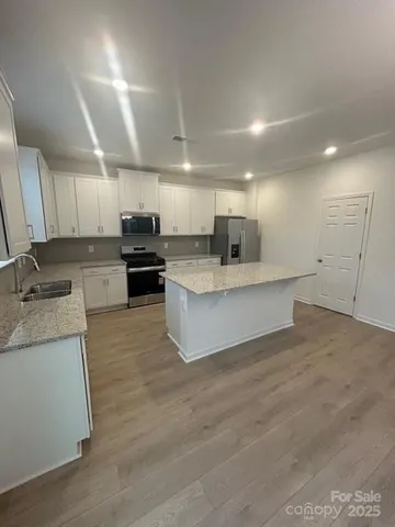 a large white kitchen with a large window