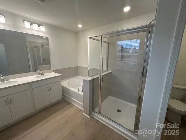 a spacious bathroom with a shower a sink and mirror