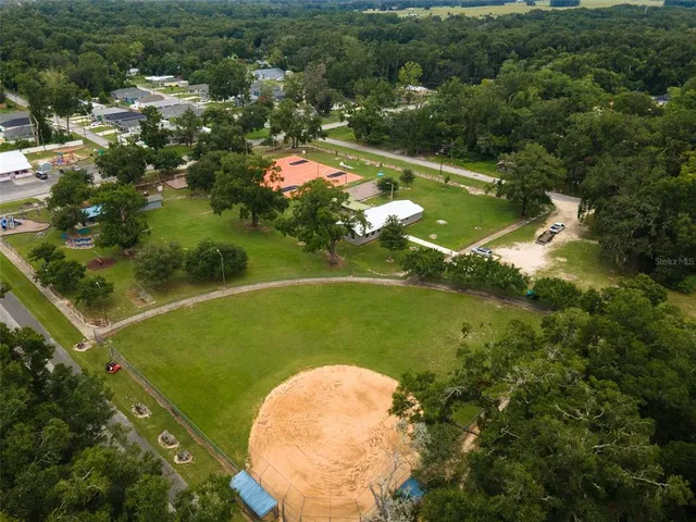 an aerial view of a house with yard swimming pool and outdoor seating