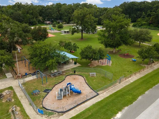 an aerial view of a house having a yard